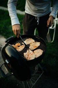 Person grilling outside.